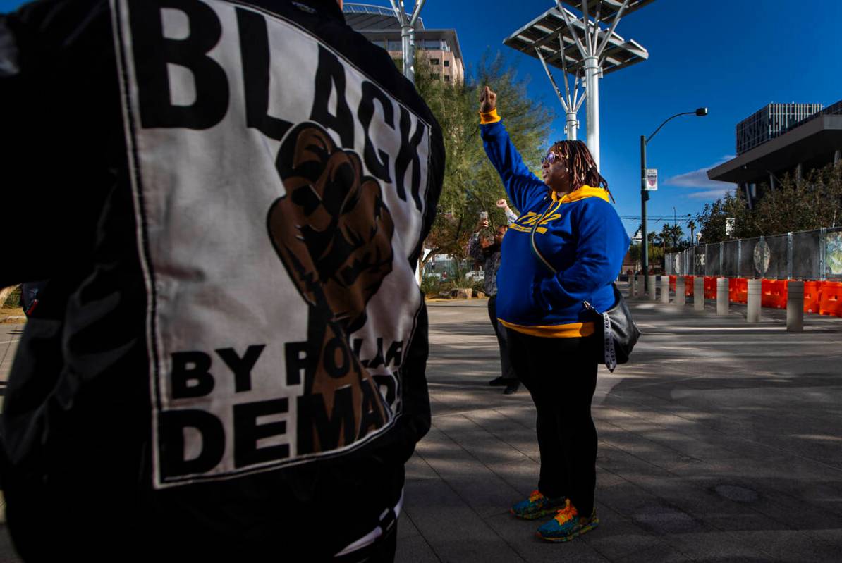 People participate in a rally for Brandon Durham, who was shot and killed by police in his own ...