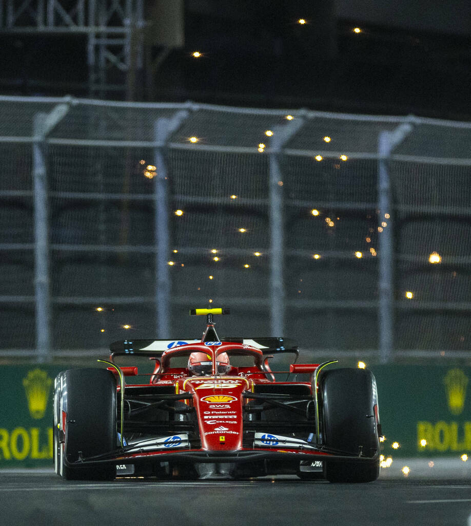 Ferrari driver Carlos Sainz sends some sparks flying while in the final turn on the track durin ...