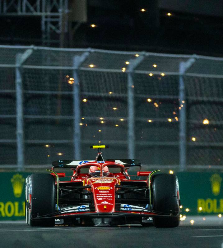 Ferrari driver Carlos Sainz sends some sparks flying while in the final turn on the track durin ...