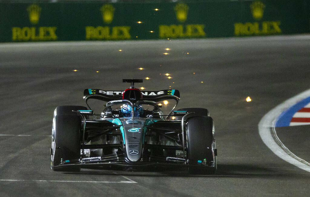 Mercedes driver George Russell sends some sparks flying while in the final turn on the track du ...