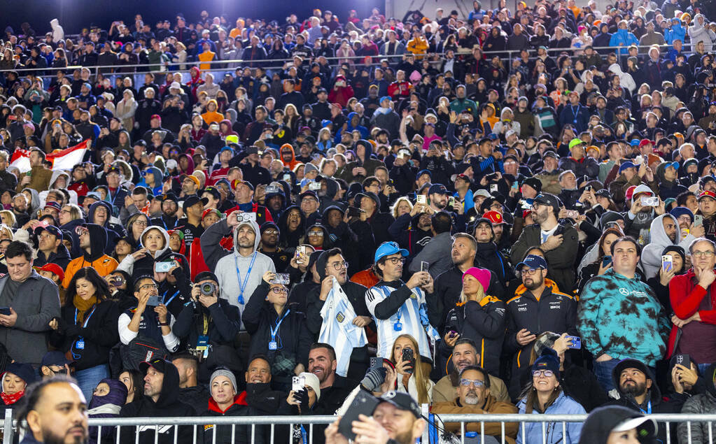 Fans stand for the finish of the race during the Formula 1 Las Vegas Grand Prix on Sunday, Nov. ...