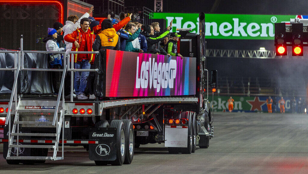 Drivers wave to fans as they take a lap after being introduced before the start of the Formula ...