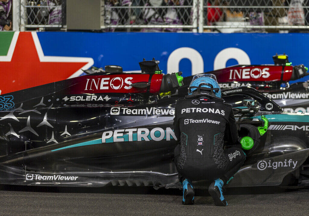 Mercedes driver George Russell takes quiet moment beside his race car after his race win at the ...