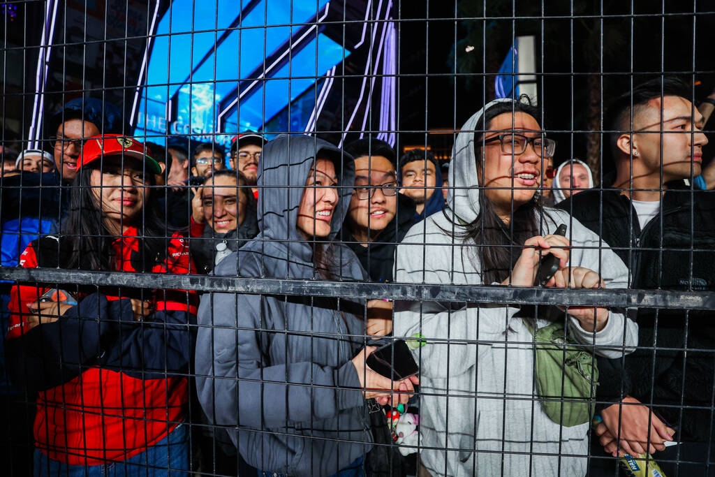 Formula 1 fans without tickets enjoy their view after parts of screens were torn down during th ...