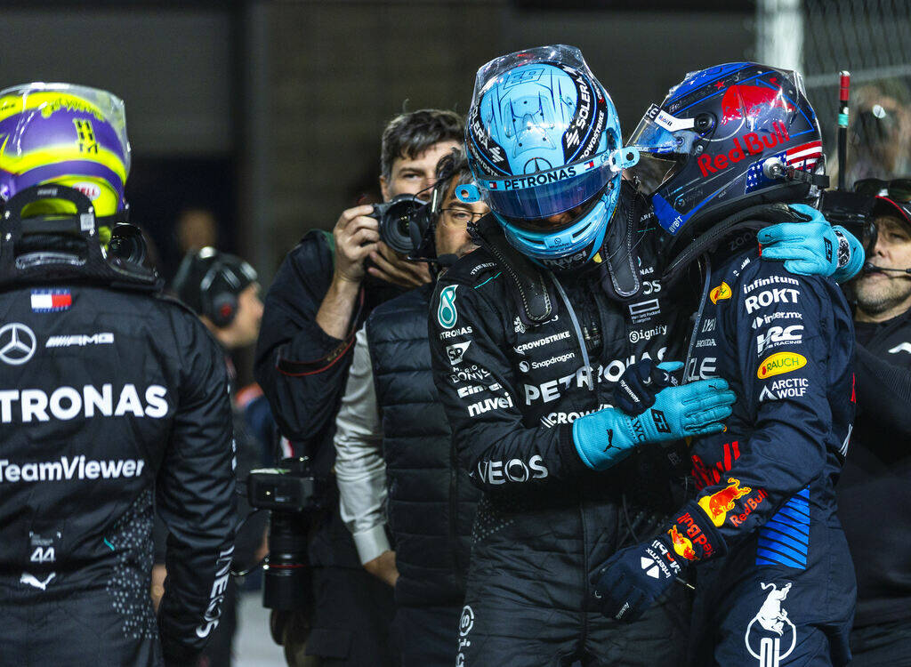 Mercedes driver George Russell hugs Red Bull Racing driver Max Verstappen as Russell wins the r ...