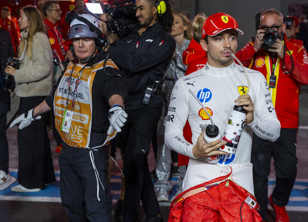 Ferrari driver Charles Leclerc walks to his car on the track before the start during the Formul ...