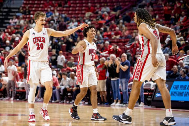 UNLV guard Julian Rishwain (20) and guard Dedan Thomas Jr. (11) look to celebrate a play with f ...