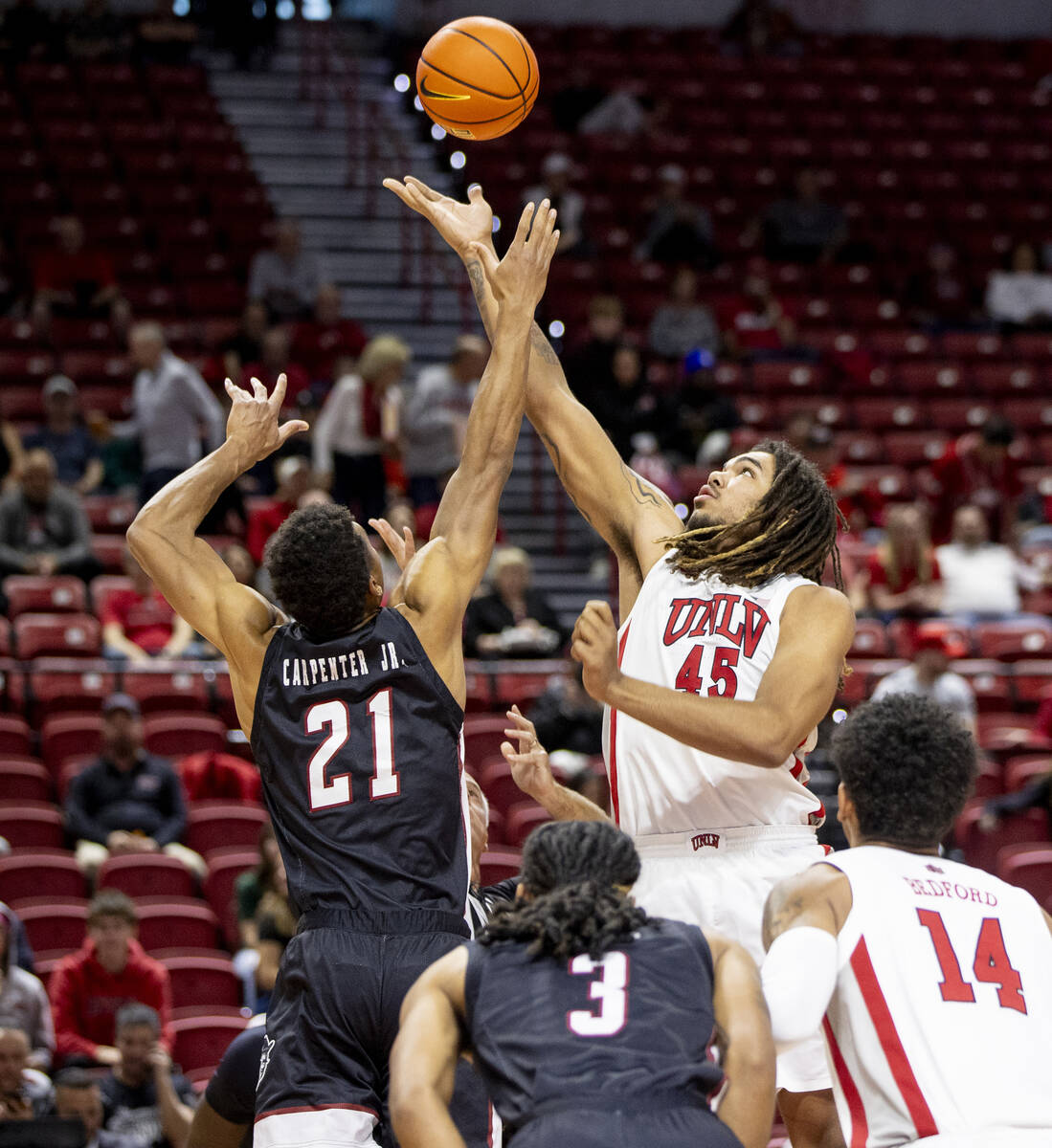 UNLV forward Jeremiah Cherry (45) and New Mexico State Aggies forward Robert Carpenter (21) com ...