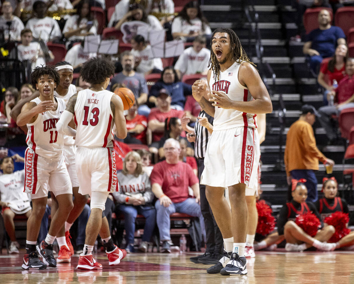 UNLV forward Jeremiah Cherry, right, is surprised by a foul called on him during the college ba ...