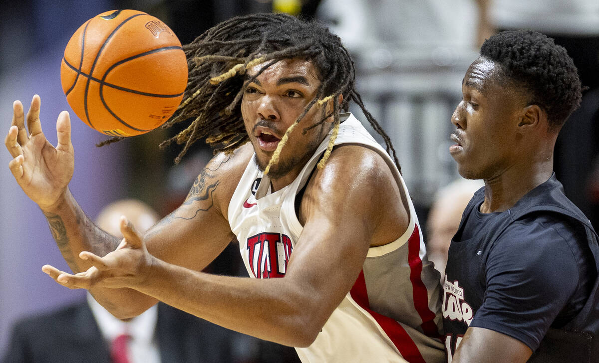 UNLV forward Jeremiah Cherry, left, loses control of the ball during the college basketball gam ...