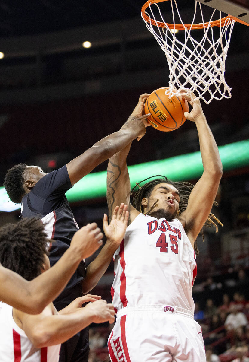 UNLV forward Jeremiah Cherry (45) grabs a rebound during the college basketball game against th ...