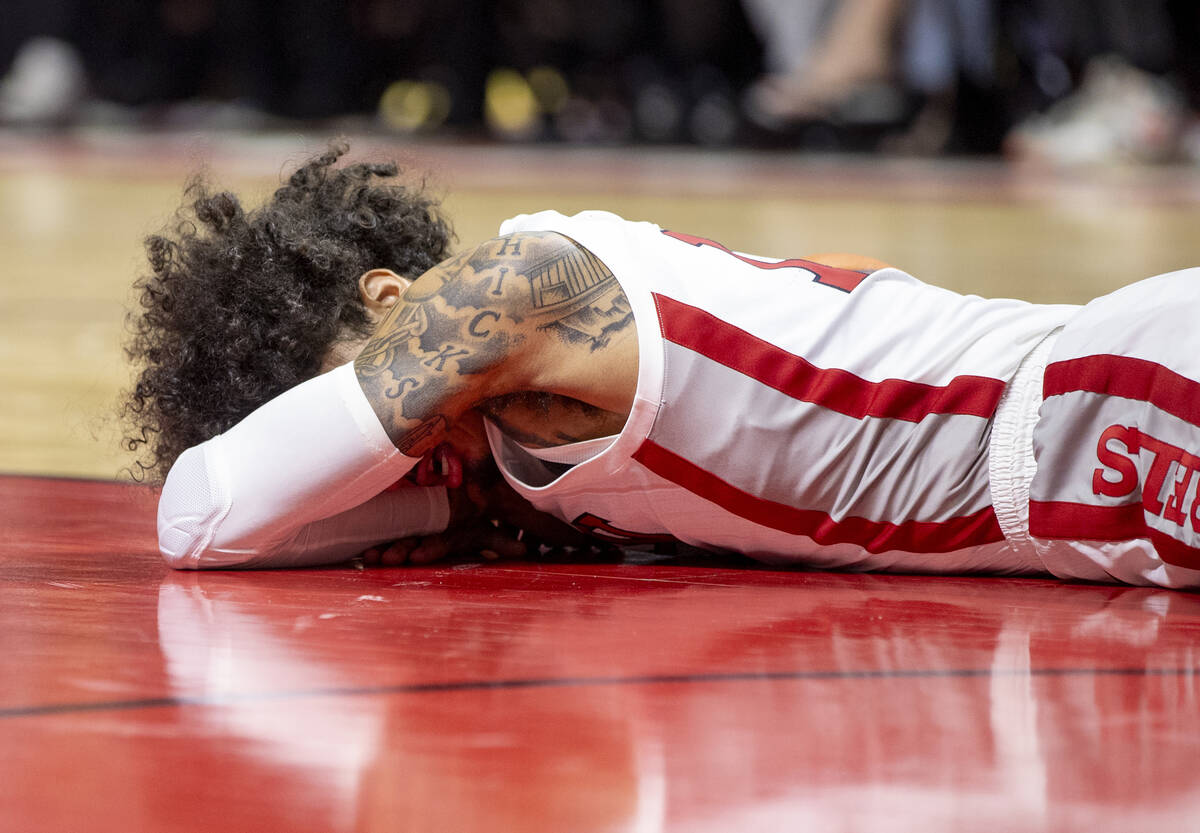 UNLV guard Brooklyn Hicks lays on the court after taking a hit to the face during the college b ...