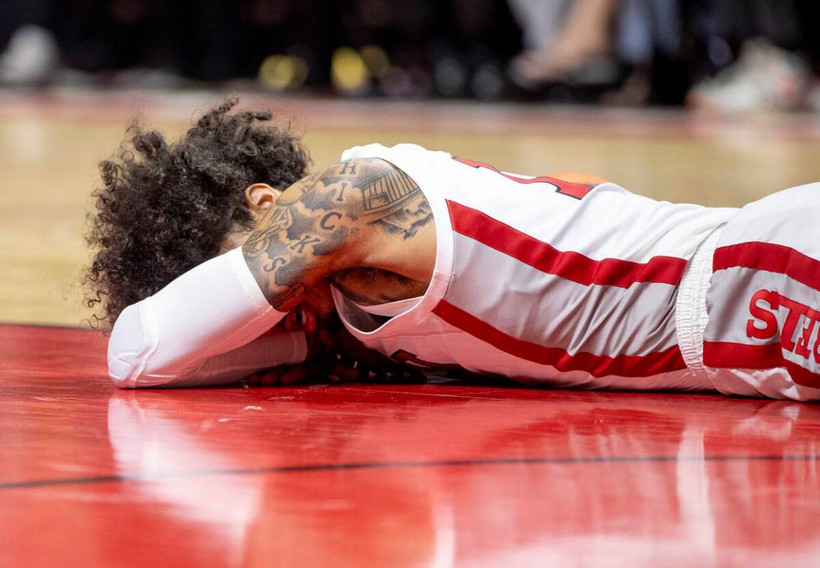 UNLV guard Brooklyn Hicks lays on the court after taking a hit to the face during the college b ...