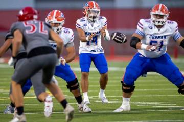 Bishop Gorman quarterback Maika Eugenio (14) snaps the ball during the high school football gam ...