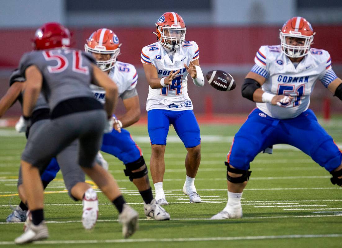 Bishop Gorman quarterback Maika Eugenio (14) snaps the ball during the high school football gam ...