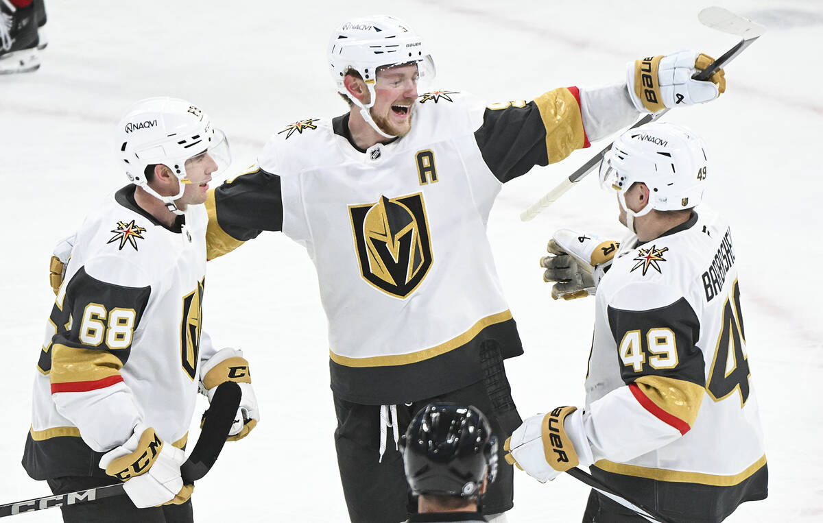 Vegas Golden Knights' Jack Eichel (9) celebrates with teammates Callahan Burke (68) and Ivan Ba ...