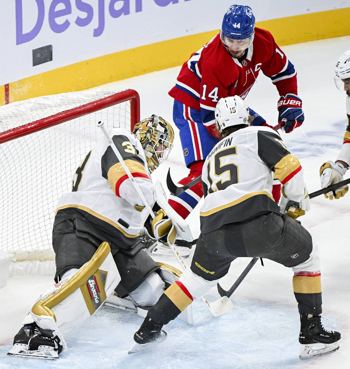 Vegas Golden Knights goaltender Adin Hill (33) stops Montreal Canadiens' Nick Suzuki (14) as Kn ...