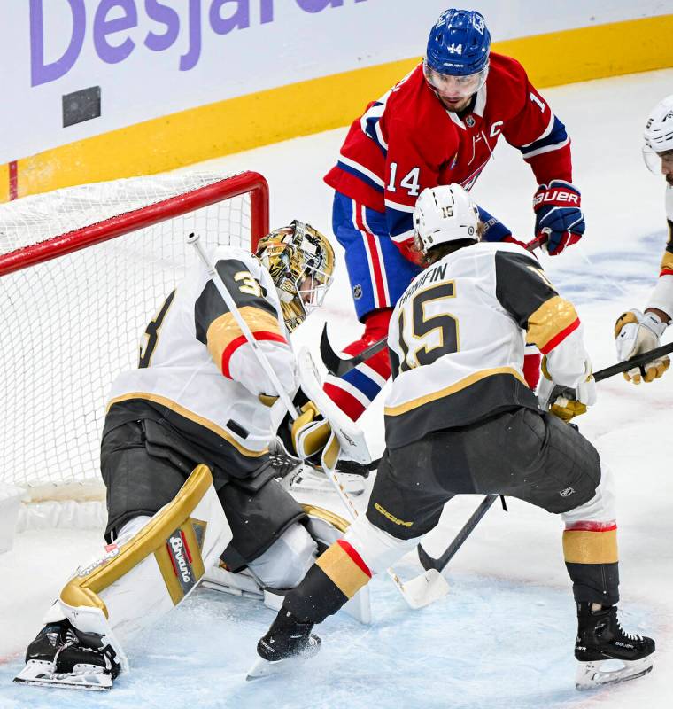 Vegas Golden Knights goaltender Adin Hill (33) stops Montreal Canadiens' Nick Suzuki (14) as Kn ...