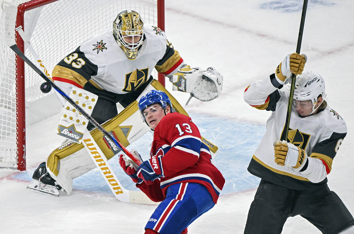 Montreal Canadiens' Cole Caufield (13) tries to knock down a loose puck as Vegas Golden Knights ...