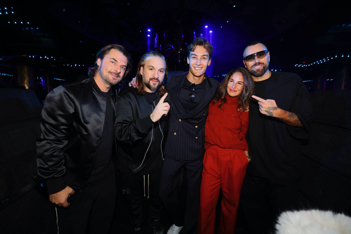 F1 Las Vegas Grand Prix champ George Russell is shown with EDM superstars Swedish House Mafia a ...