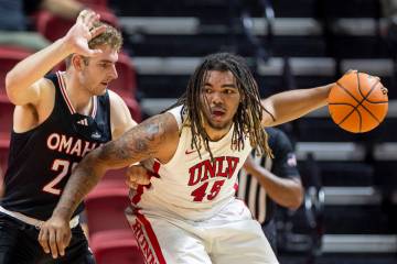 Omaha Mavericks forward Joshua Streit, left, and UNLV forward Jeremiah Cherry (45) compete duri ...