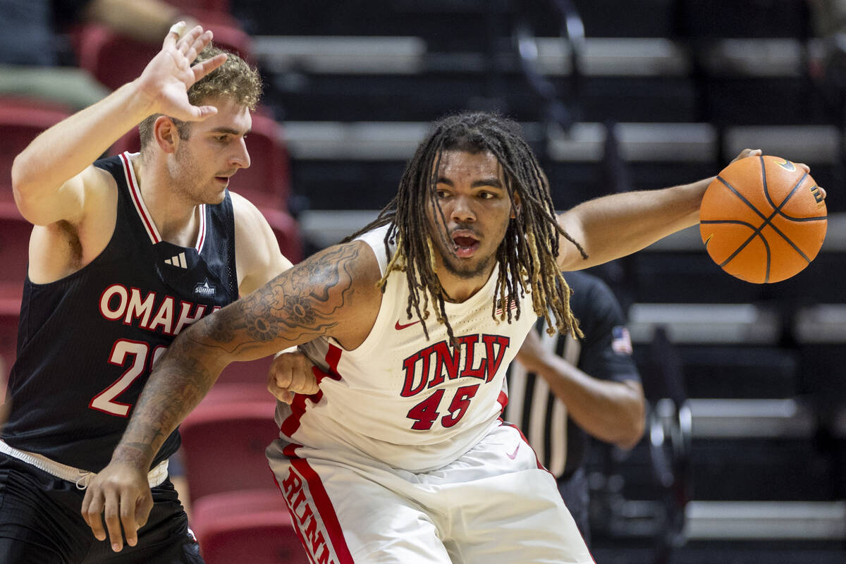 Omaha Mavericks forward Joshua Streit, left, and UNLV forward Jeremiah Cherry (45) compete duri ...