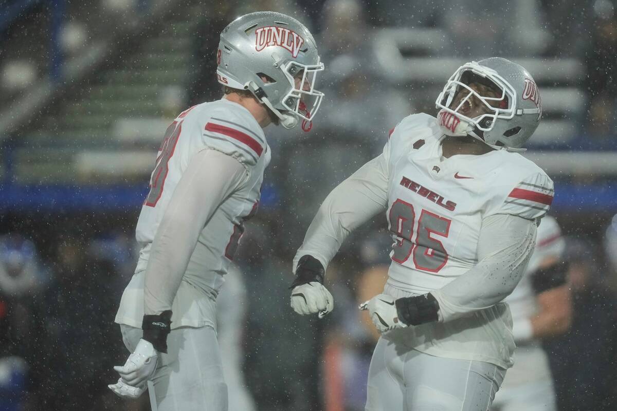 UNLV defensive lineman Alexander Whitmore, right, reacts after making a tackle against San Jose ...