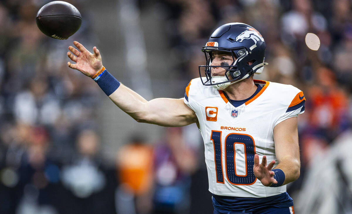 Denver Broncos quarterback Bo Nix (10) gets off a pass against the Raiders during the first hal ...