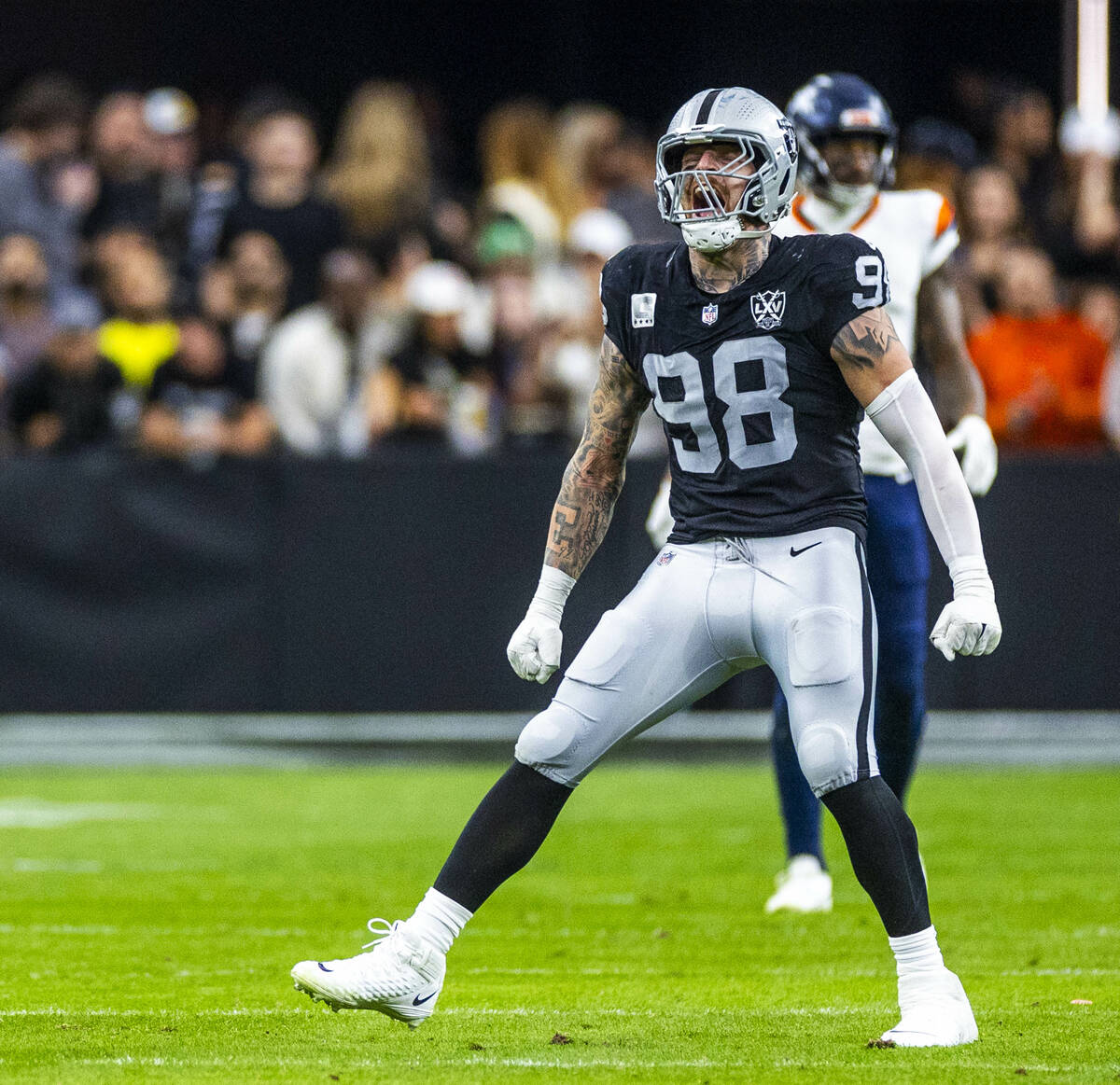 Raiders defensive end Maxx Crosby (98) celebrates a Denver Broncos defensive stop during the fi ...