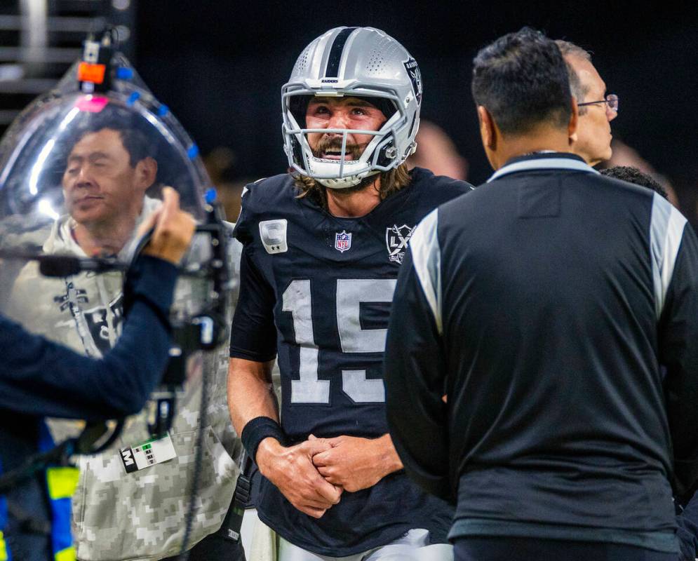 Raiders quarterback Gardner Minshew (15) exits the field after a sack led to a collarbone injur ...