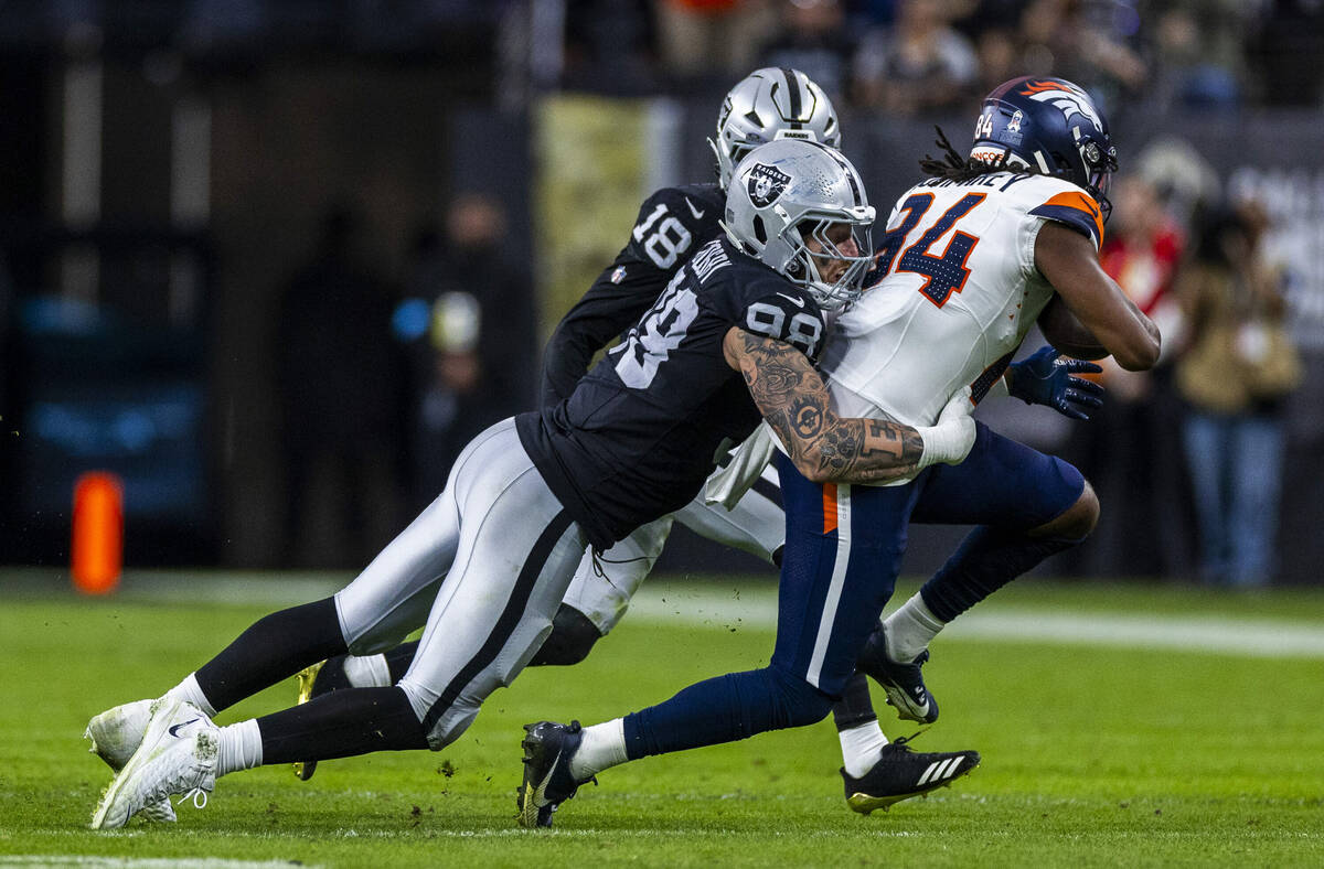 Raiders defensive end Maxx Crosby (98) stops Denver Broncos wide receiver Lil'Jordan Humphrey ( ...