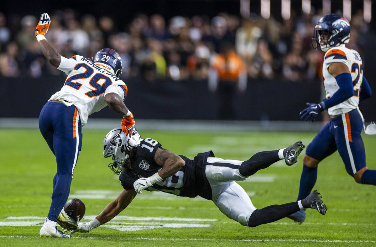 Raiders wide receiver Jakobi Meyers (16) misses a pass saw Denver Broncos cornerback Ja'Quan Mc ...