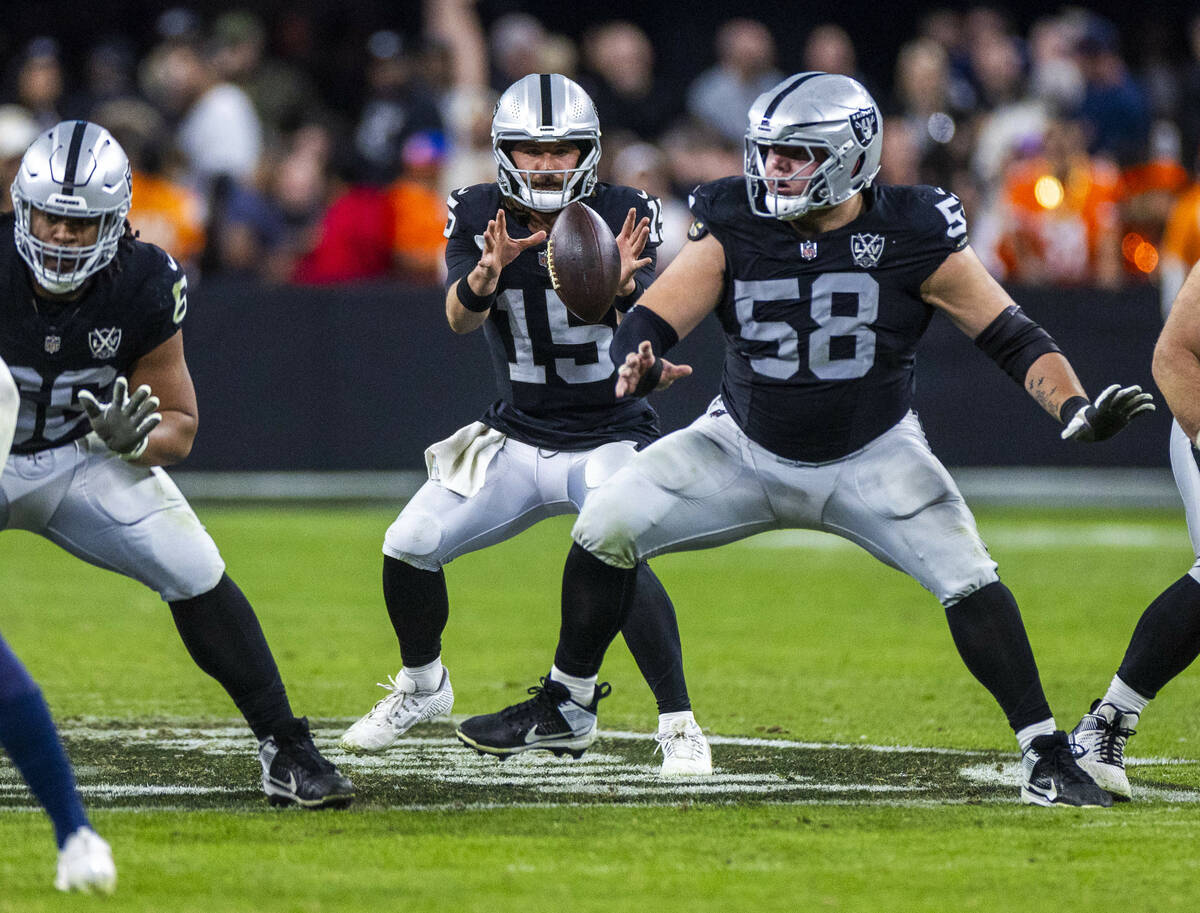 Raiders quarterback Gardner Minshew (15) awaits the snap against the Denver Broncos during the ...