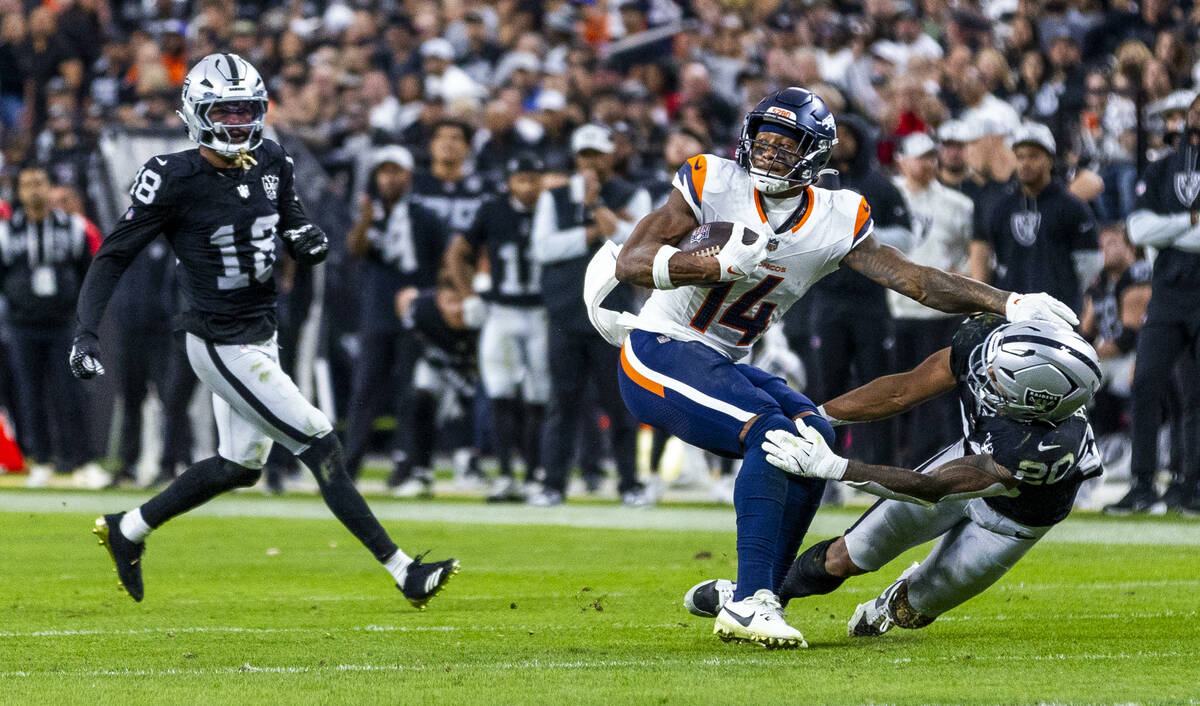 Denver Broncos wide receiver Courtland Sutton (14) shakes off Raiders safety Isaiah Pola-Mao (2 ...