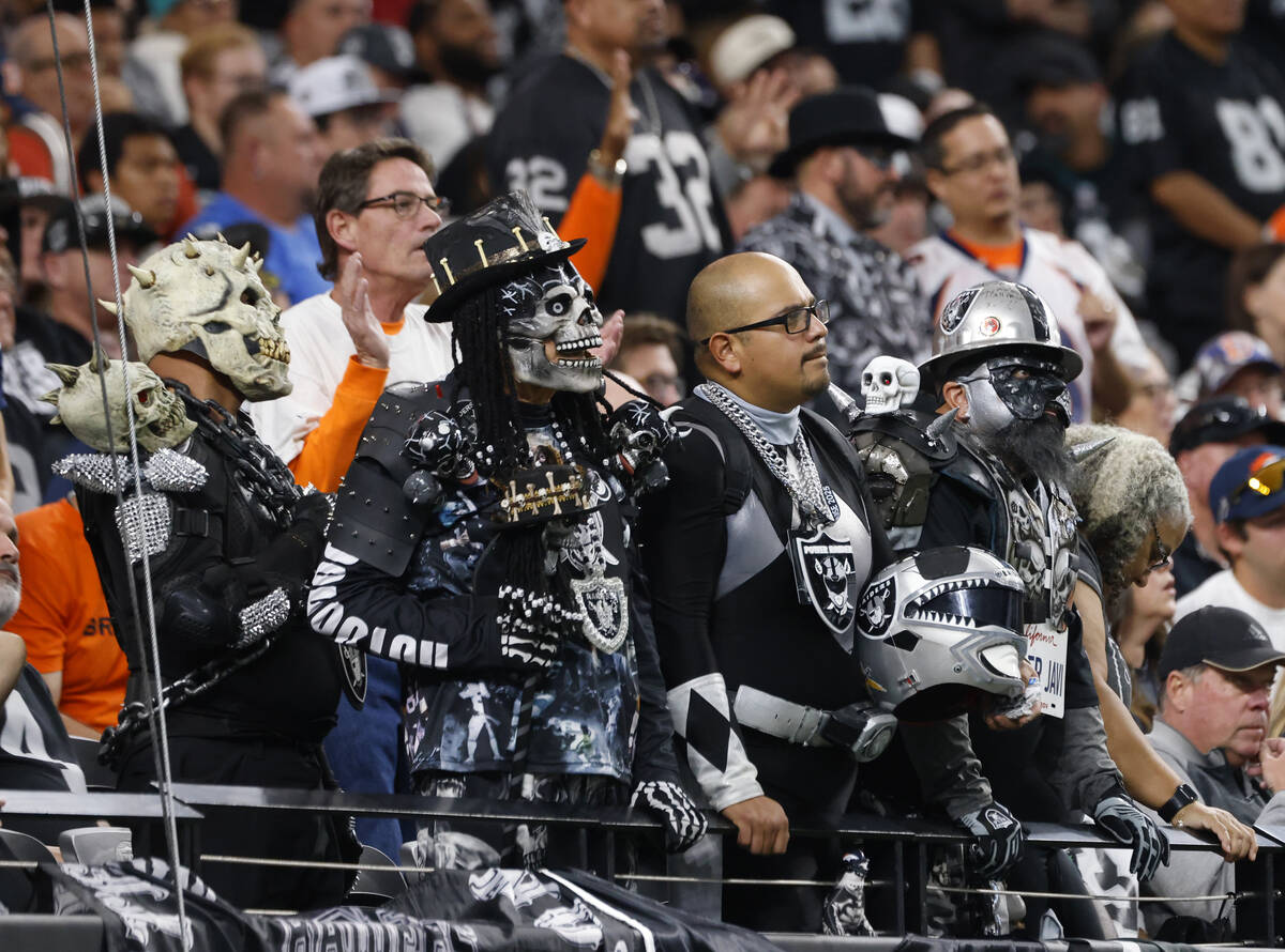 Raiders fans watch their team during an NFL game against the Denver Broncos at the Allegiant St ...