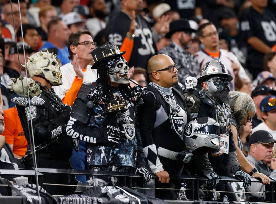 Raiders fans watch their team during an NFL game against the Denver Broncos at the Allegiant St ...