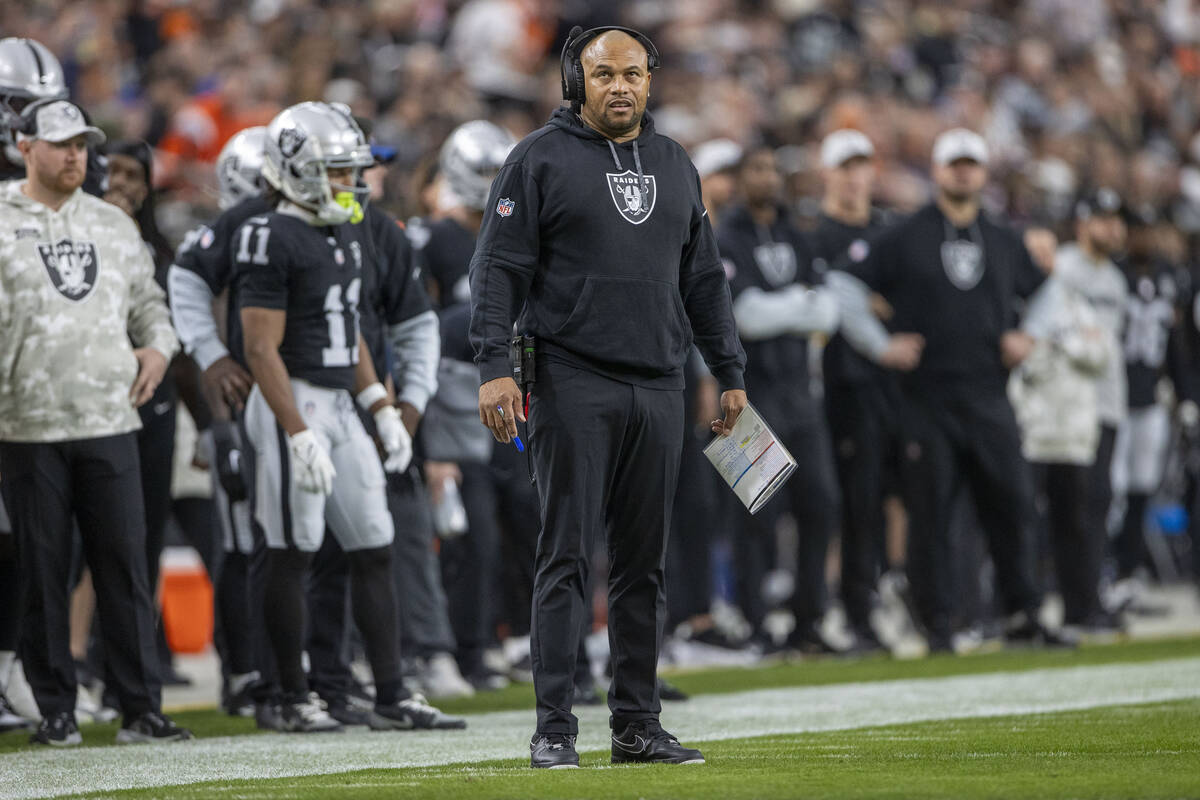 Raiders head coach Antonio Pierce looks to a replay screen after the team was penalized during ...