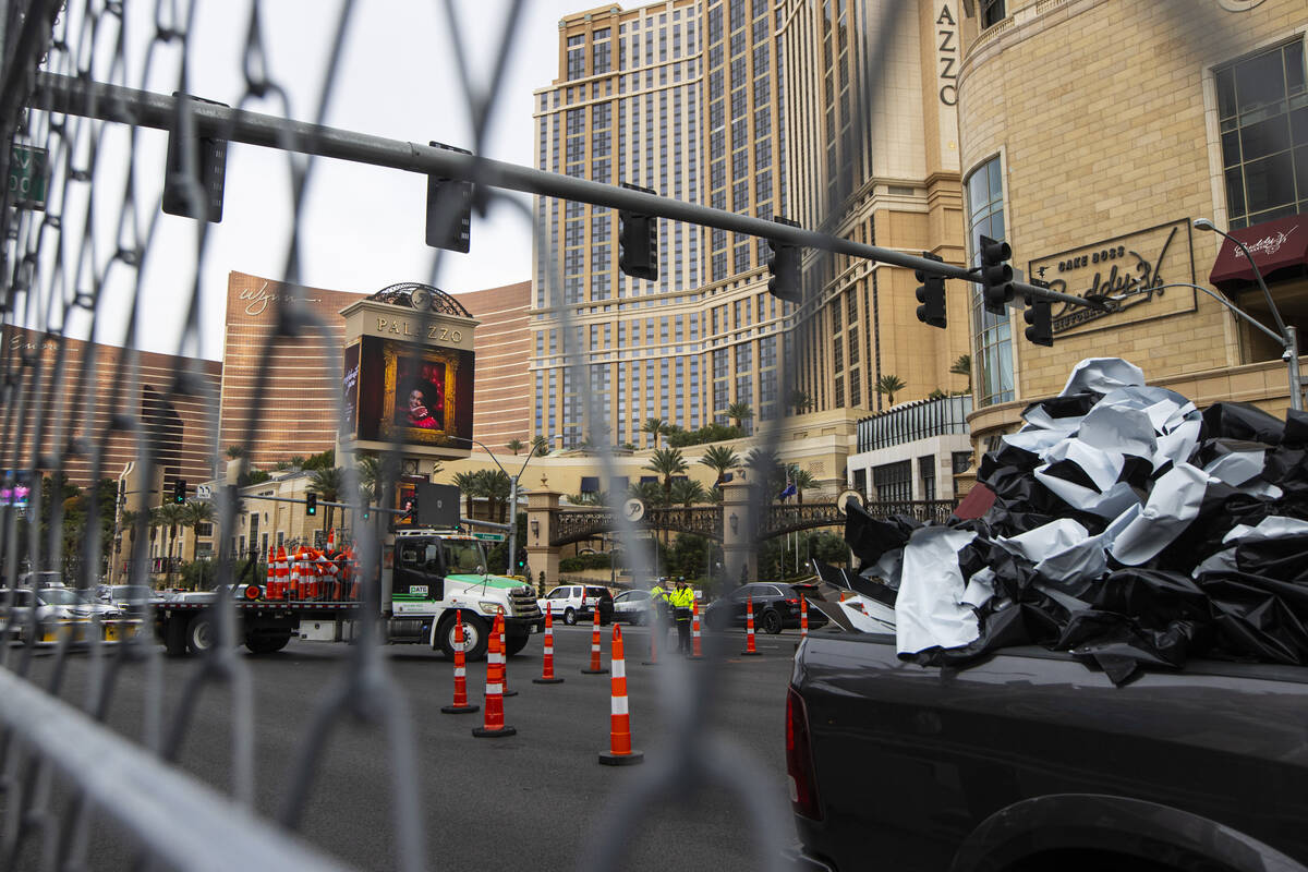 Crews work to take down the Formula One Las Vegas Grand Prix track and repaint lane markings al ...