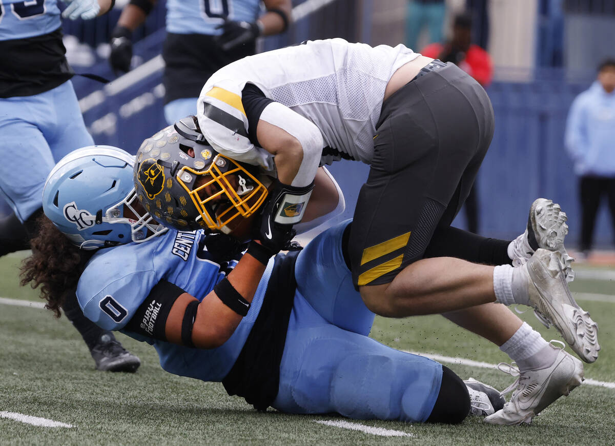 Centennial High's Saione Inoke (0) takes down Galena High tight end Ben Imse (17) during their ...