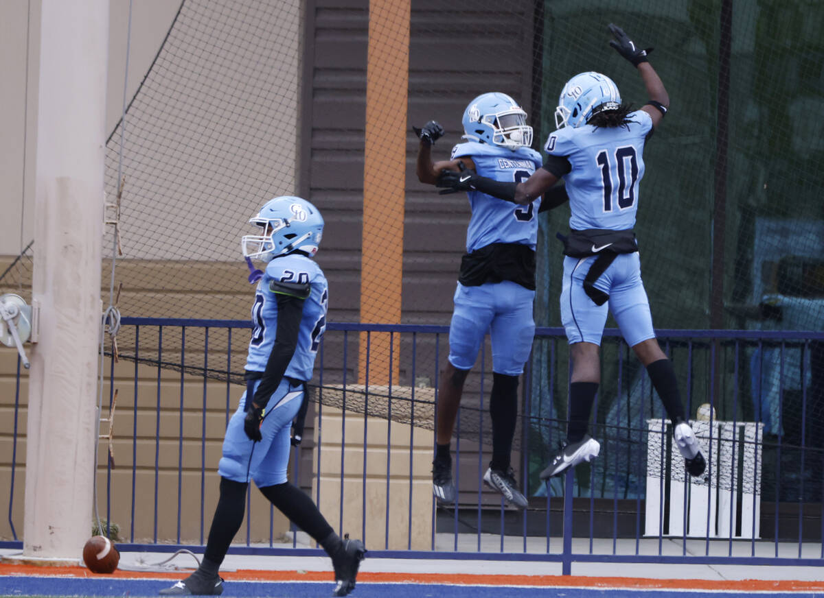 Centennial High players celebrate after cornerback Jhbari Christmas (9) intercepts a pass durin ...