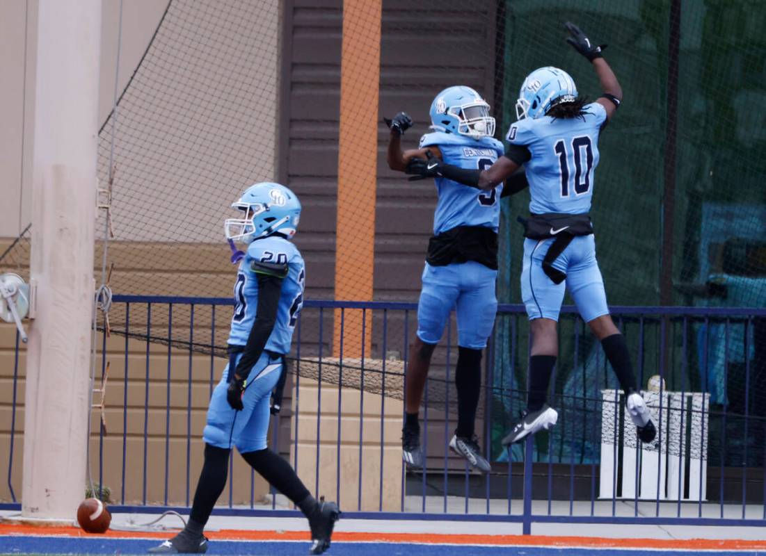 Centennial High players celebrate after cornerback Jhbari Christmas (9) intercepts a pass durin ...