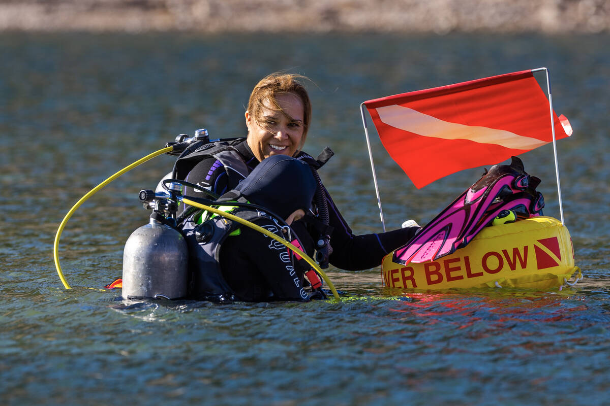 Kim Moronen smiles as her daughter Elanor Moronen, 11, gears up for a dive with Sin City Scuba ...