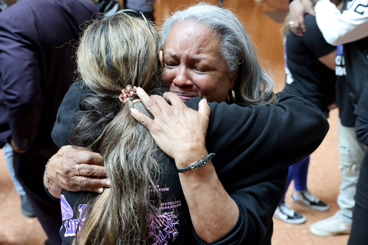 Lenore De Jesus, facing, and Jada Durham, mother and niece of Brandon Durham, who was shot and ...