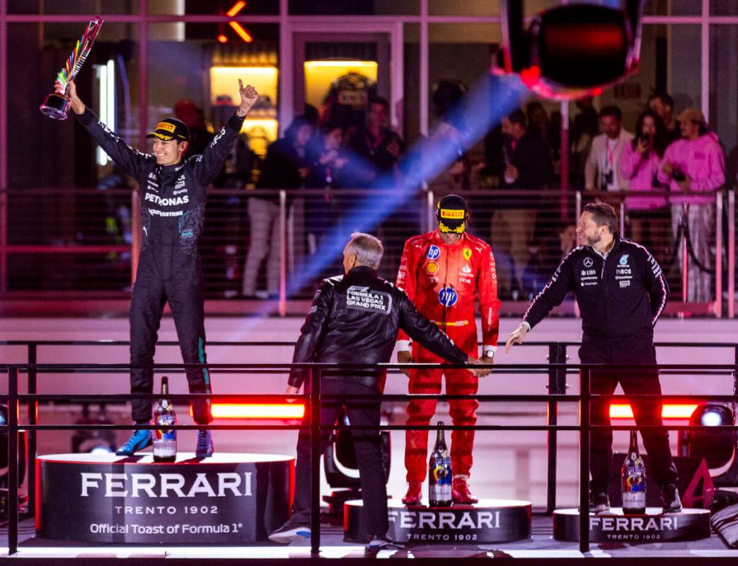 Mercedes driver George Russell celebrates his race win and trophy atop the podium during the Fo ...