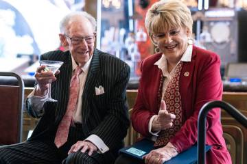 Former Mayor Oscar Goodman and his wife, Mayor Carolyn Goodman, react on the stage prior to a r ...