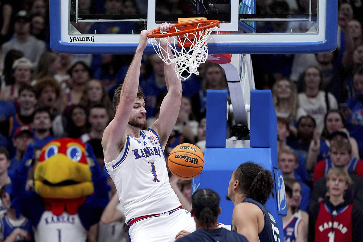 Kansas center Hunter Dickinson dunks the ball during the second half of an NCAA college basketb ...