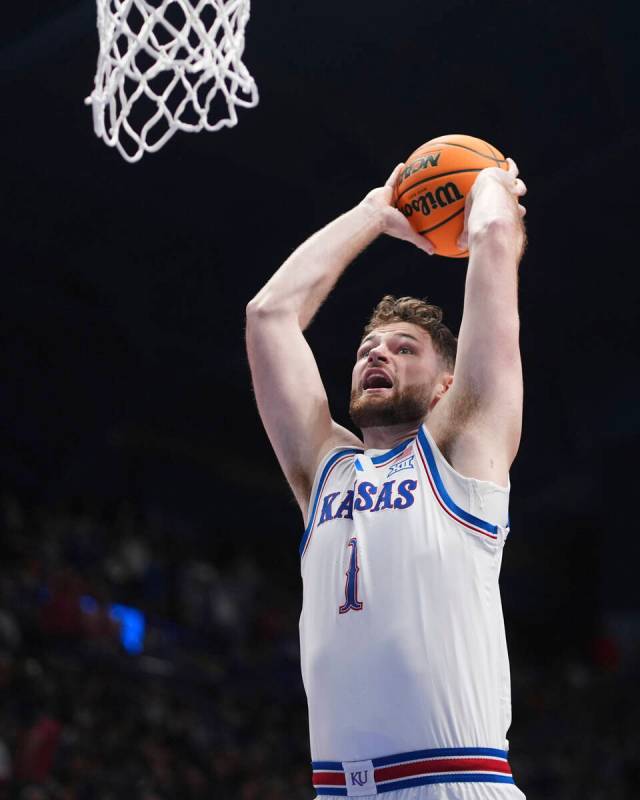 Kansas center Hunter Dickinson shoots during the first half of an NCAA college basketball game ...