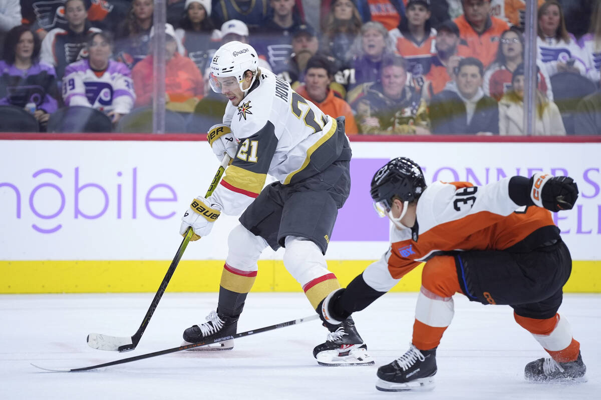 Vegas Golden Knights' Brett Howden, left, tries to keep the puck away from Philadelphia Flyers' ...