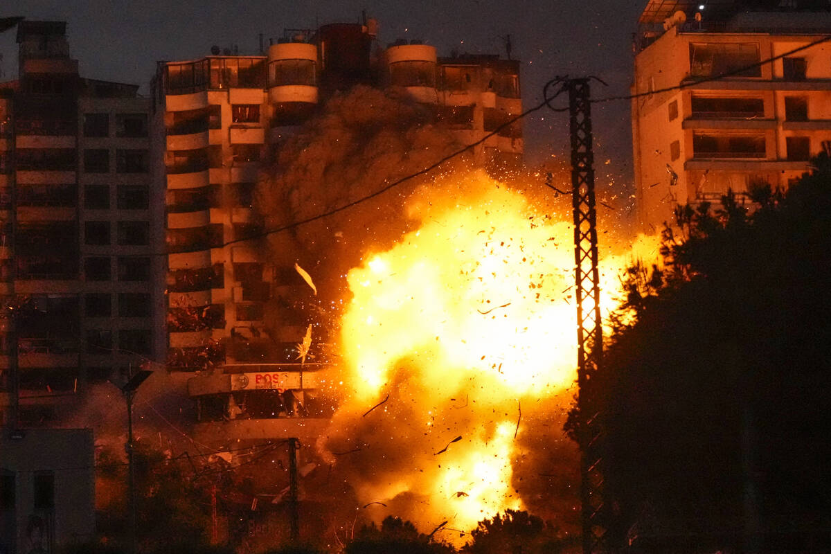 Thick smoke and flames erupt from an Israeli airstrike in Tayouneh, Beirut, Lebanon, Monday, No ...