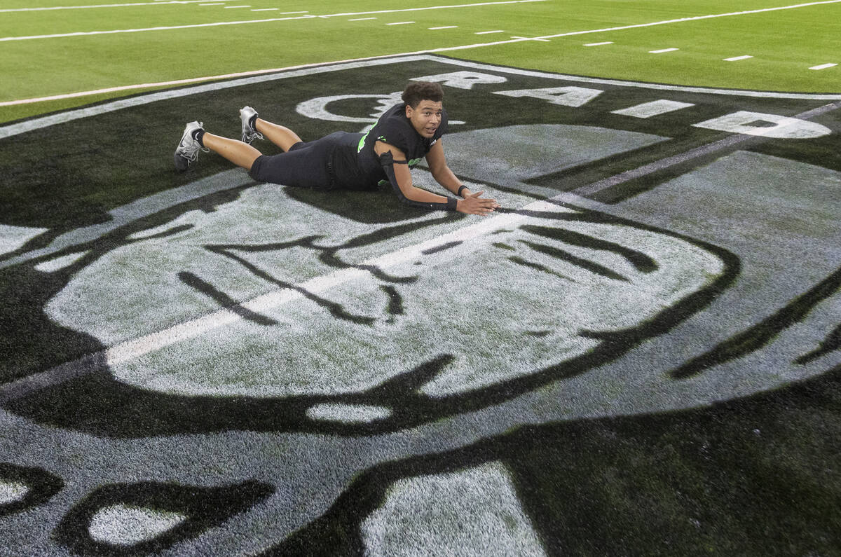 SLAM Academy freshman Czar Soto slides onto the centerfield logo, waiting to take a team photog ...